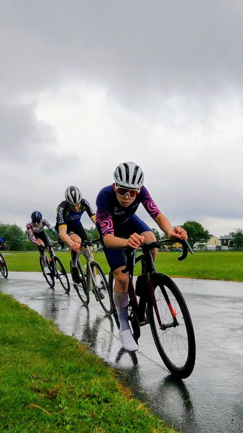 Cyclists riding together on a wet road