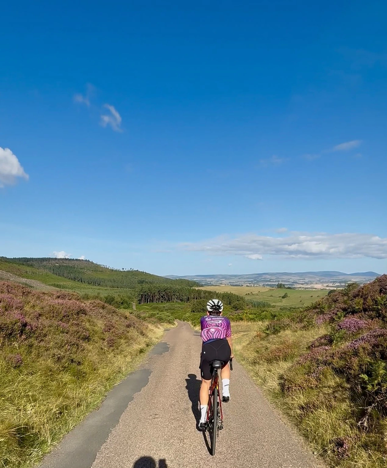 Cyclist riding through open countryside
